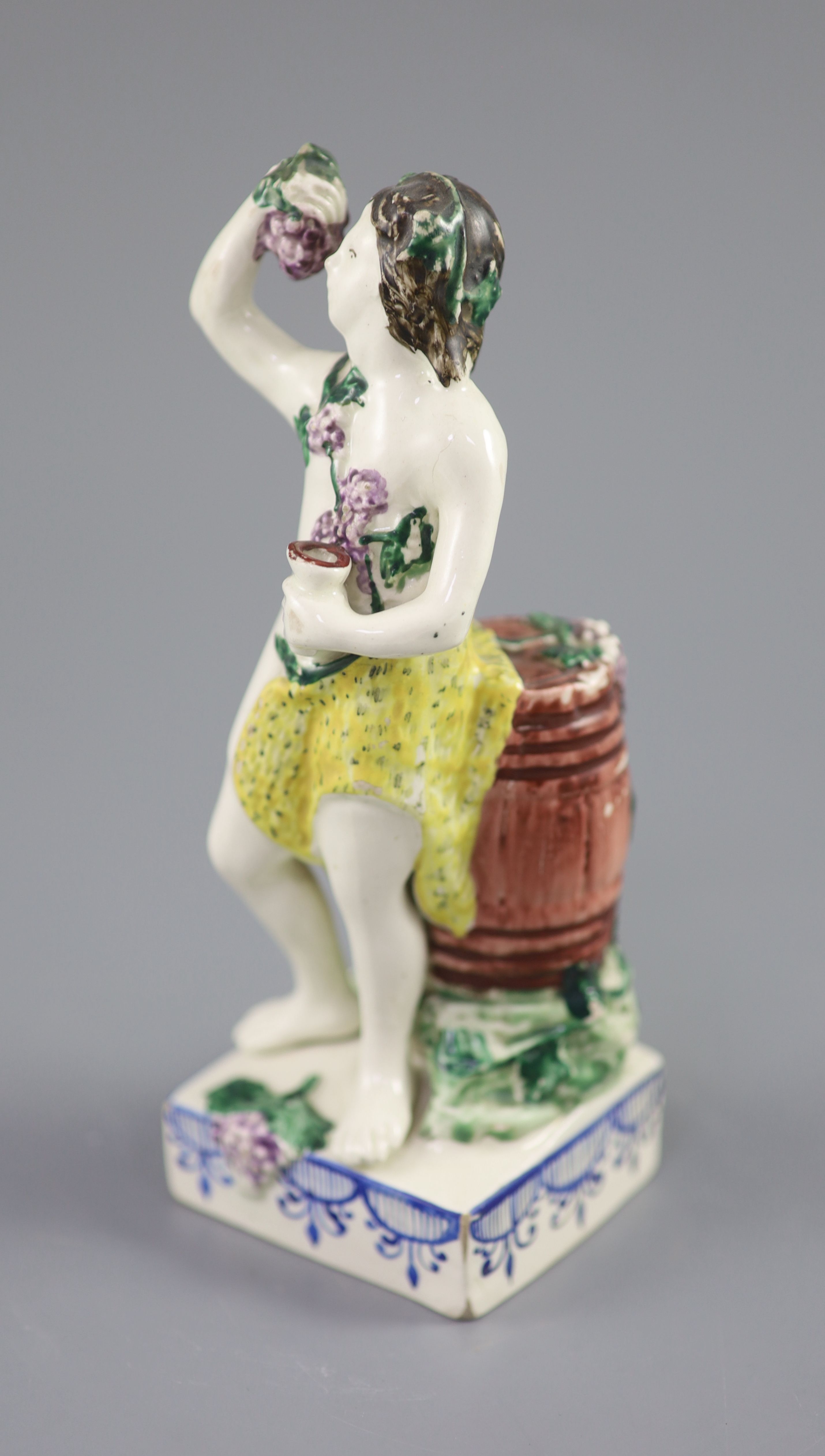 An enamelled creamware figure of Bacchus, attributed Leeds Pottery, c.1790-1800, 17.5cm high